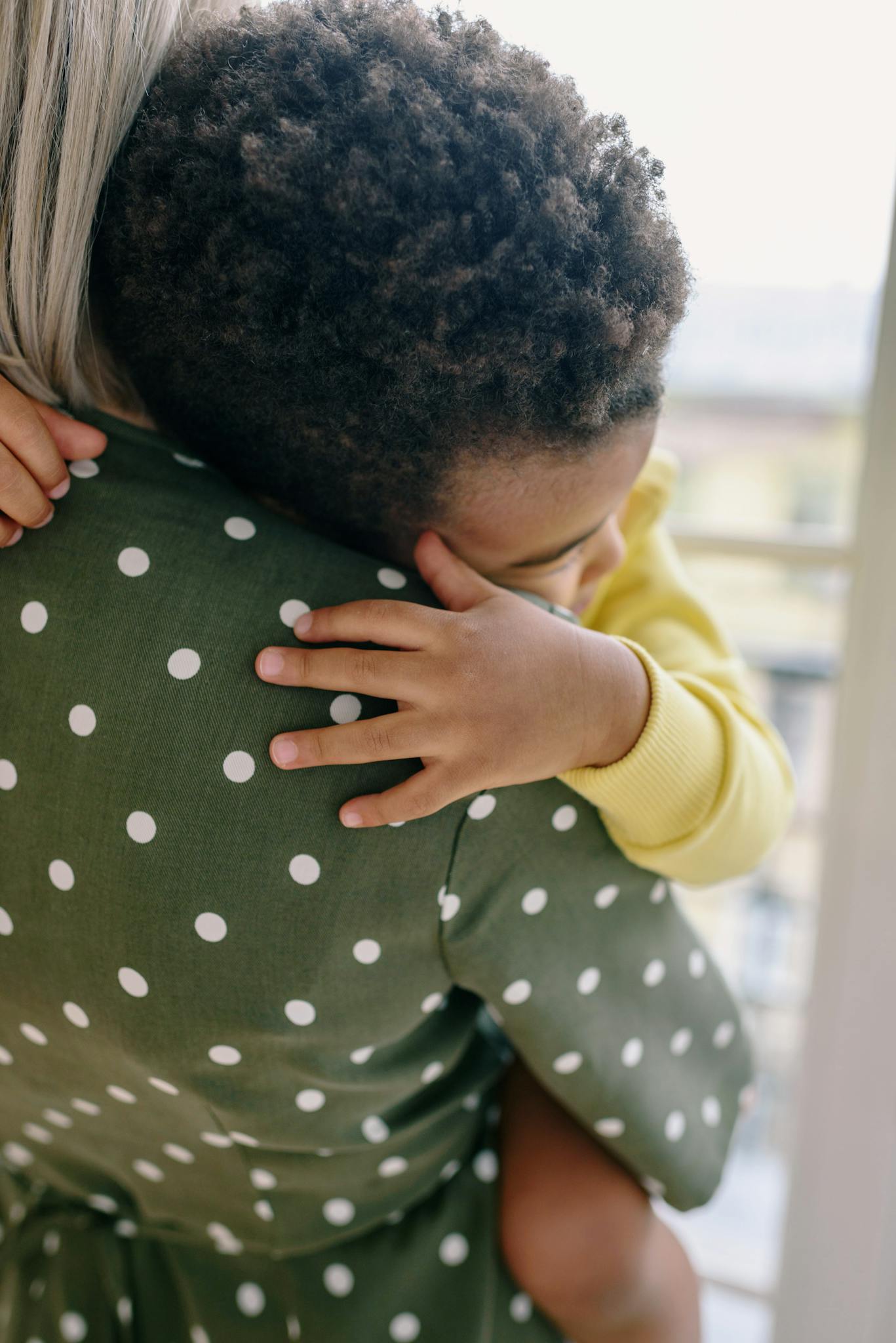 A heartwarming moment of a child hugging their mother indoors, showcasing love and bonding.