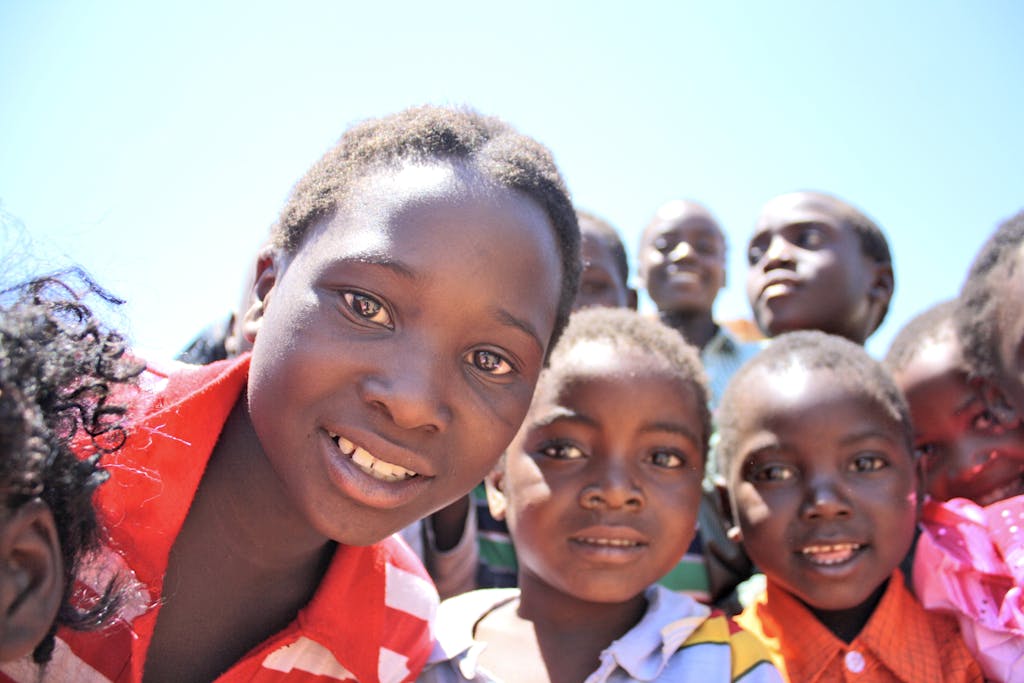 A vibrant portrait of children smiling and enjoying a sunny day outdoors